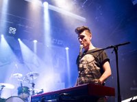 Bastille  Dan Smith performing on keyboards in his red high top chucks.